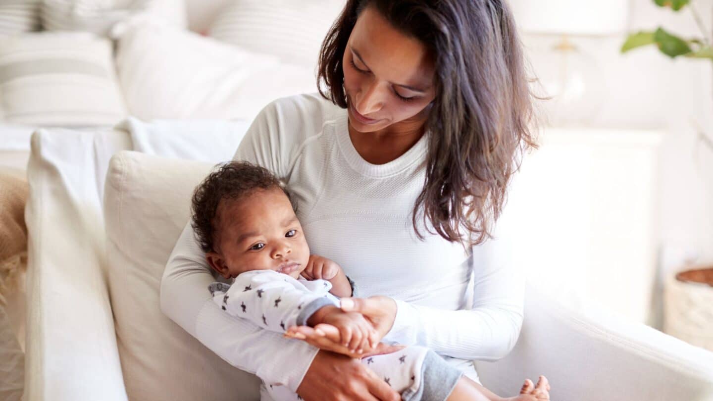 my breastfeeding journey has come to an end mom snuggling baby