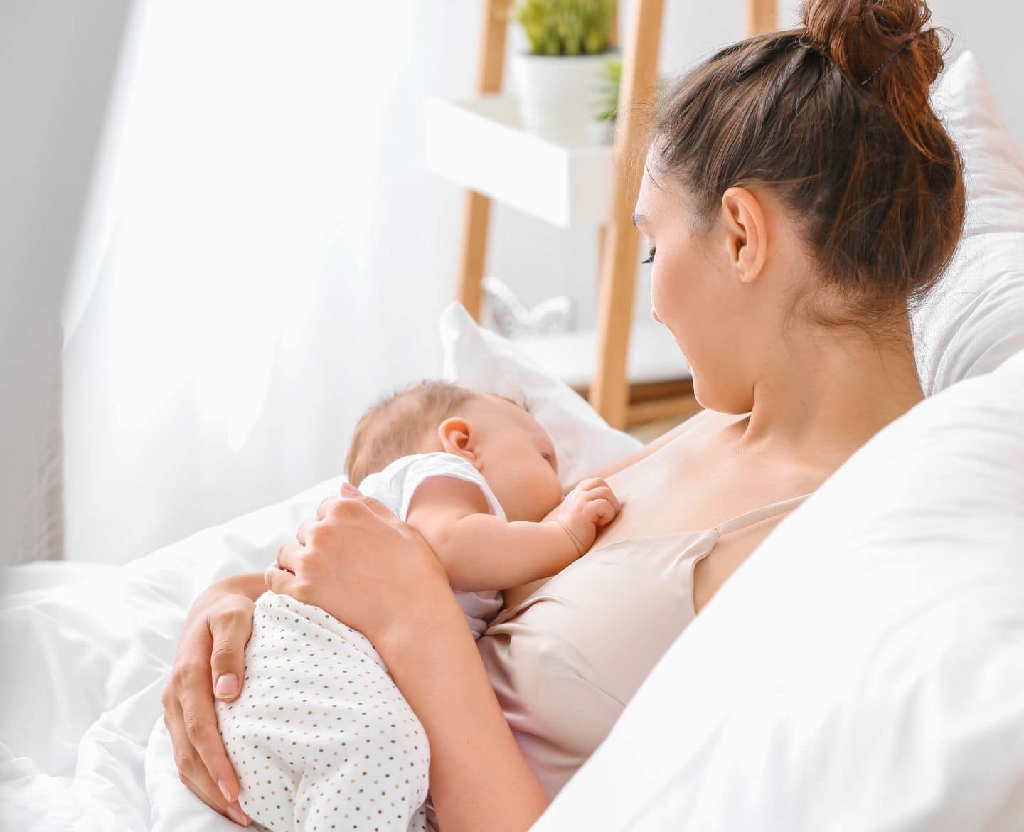 mom breastfeeding child - national breastfeeding month