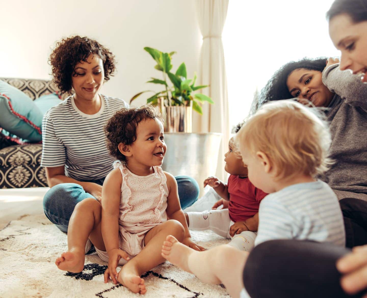 moms and babies sitting on floor - mom group