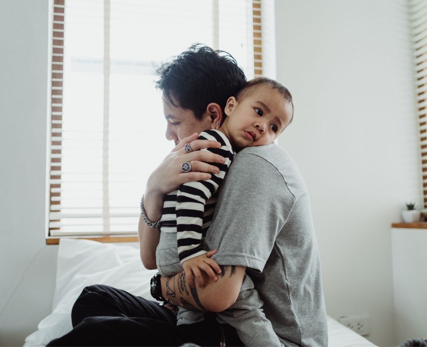 mother hugging child on bed - bedtimes for kids