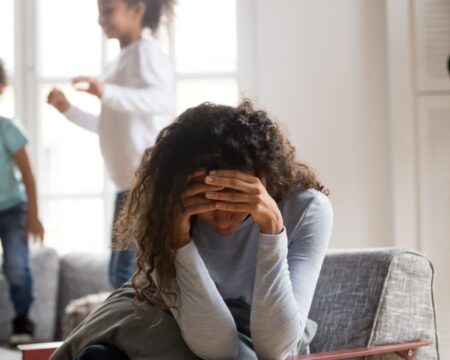 stressed mom with head in hands