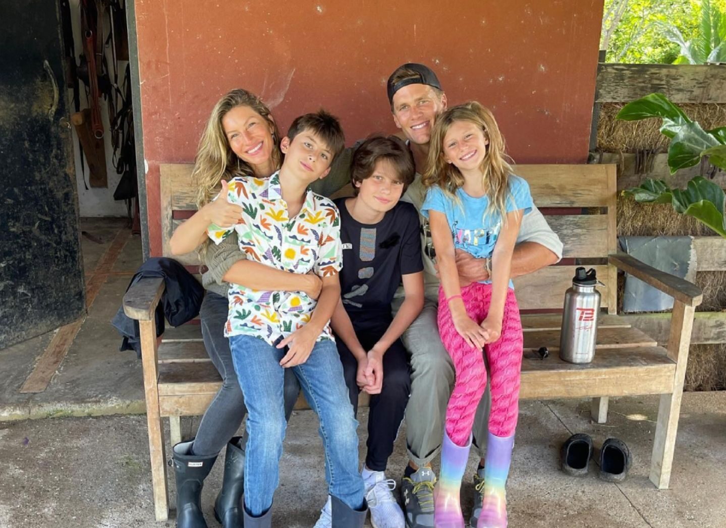 tom brady and family sitting on a bench altogether