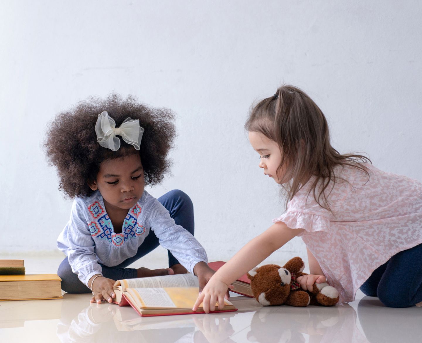 two girls learning to share toys