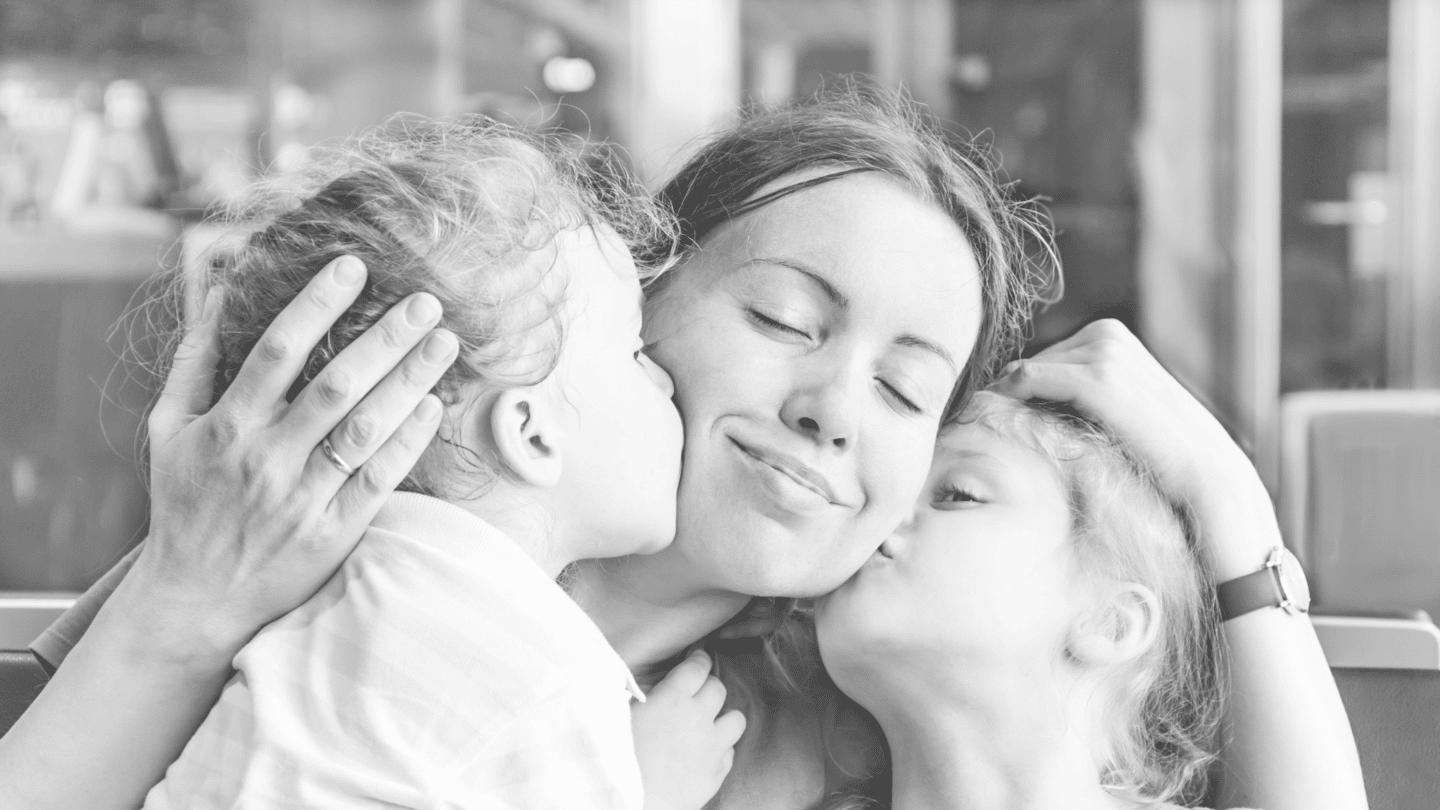 two daughters kissing mom on cheek - changing mom role