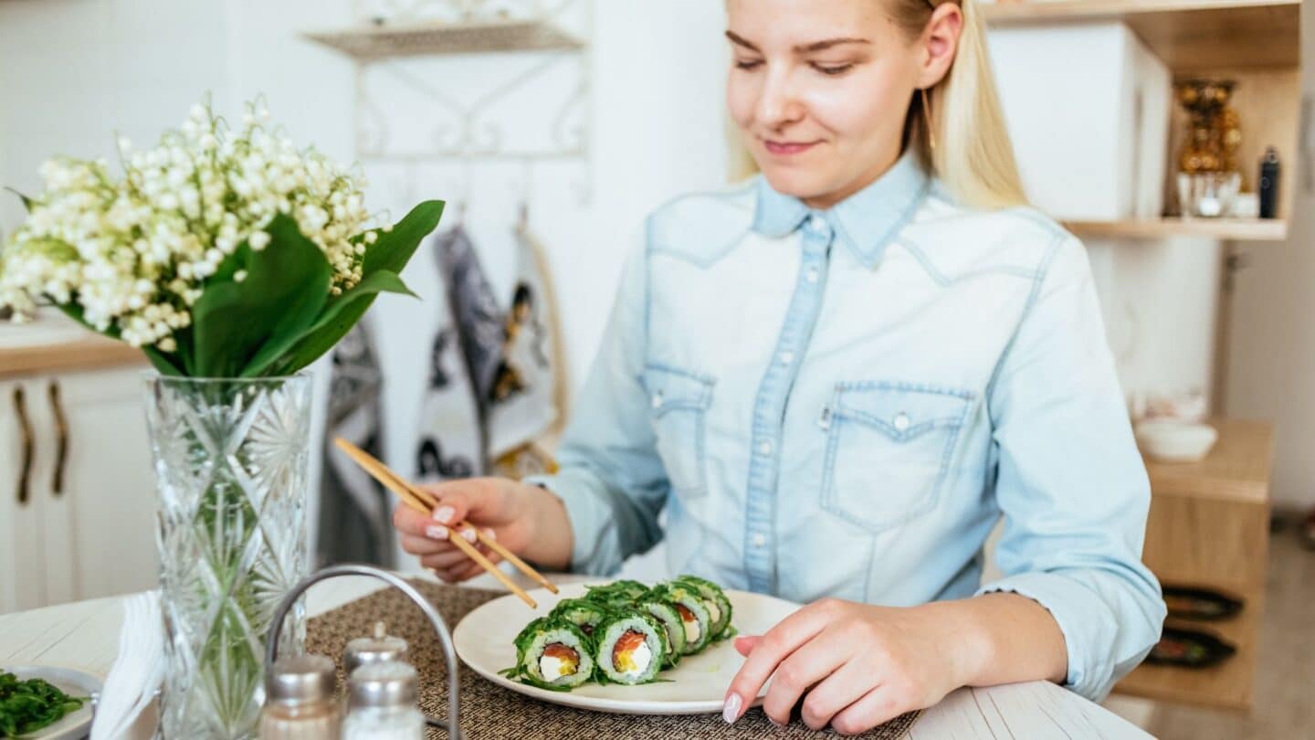 woman eating sushi at home - can i eat sushi while pregnant