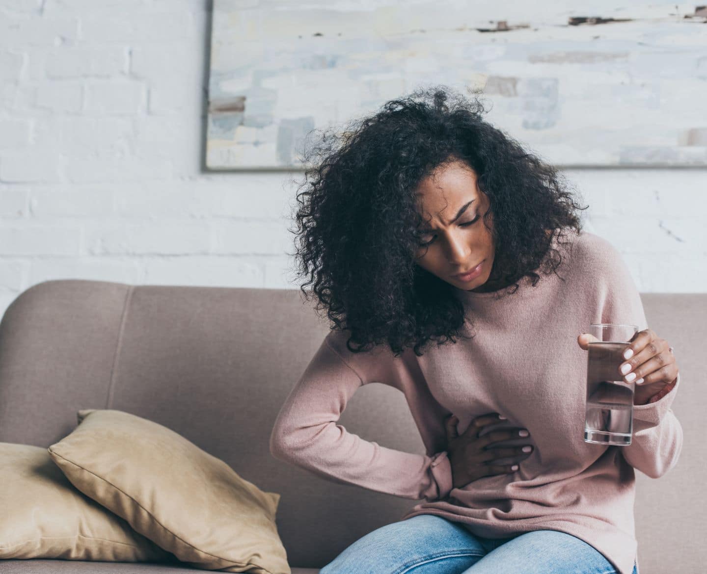 woman holding her abdomen - fibroids