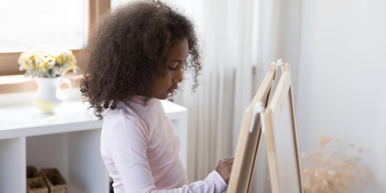 introverted child drawing on a whiteboard