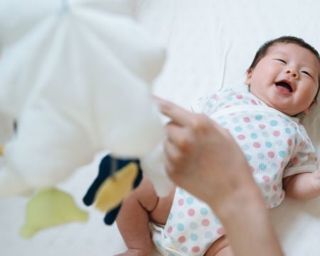 baby smiling in a crib - crib in closet ideas