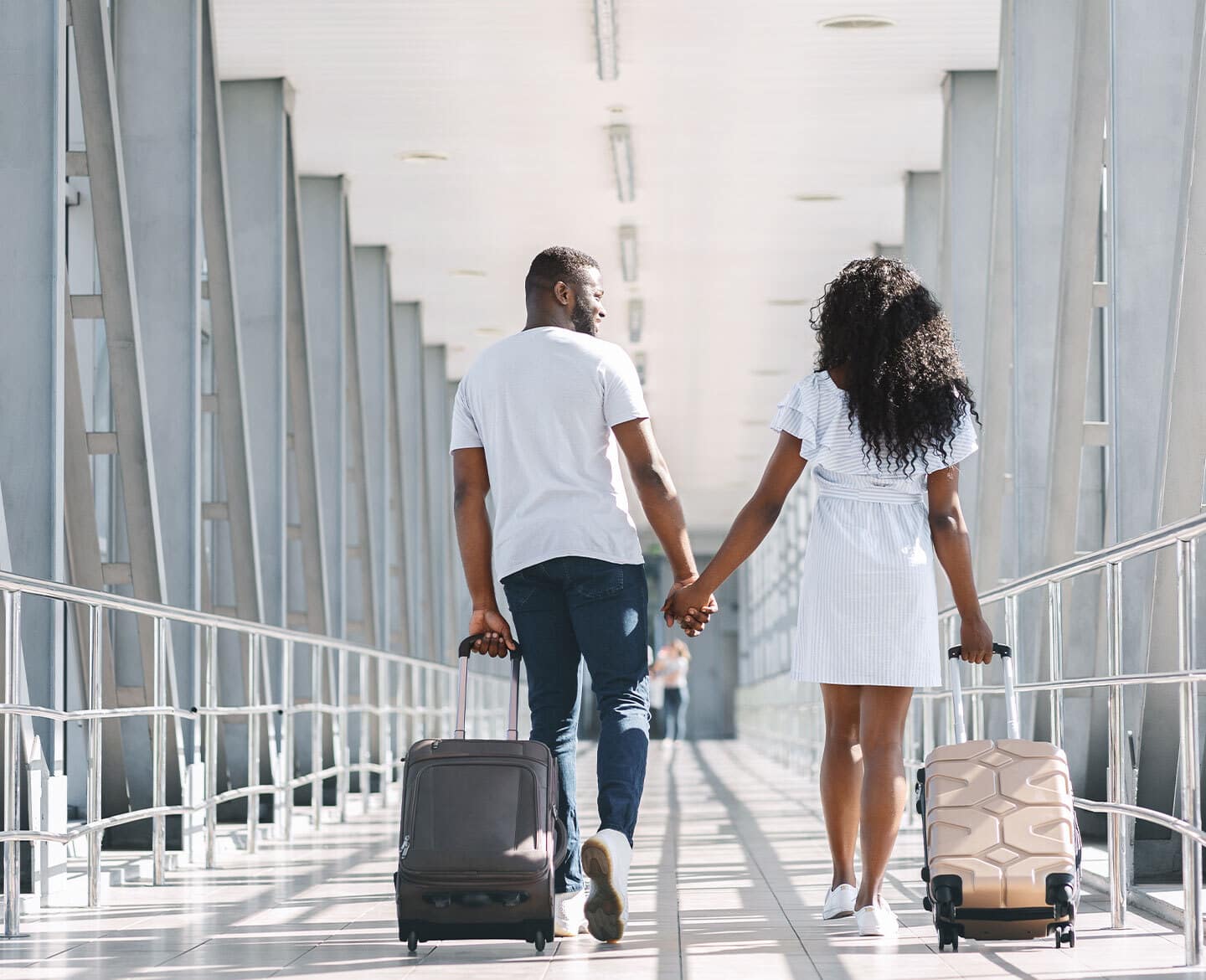 young couple at airport - best day to book flights