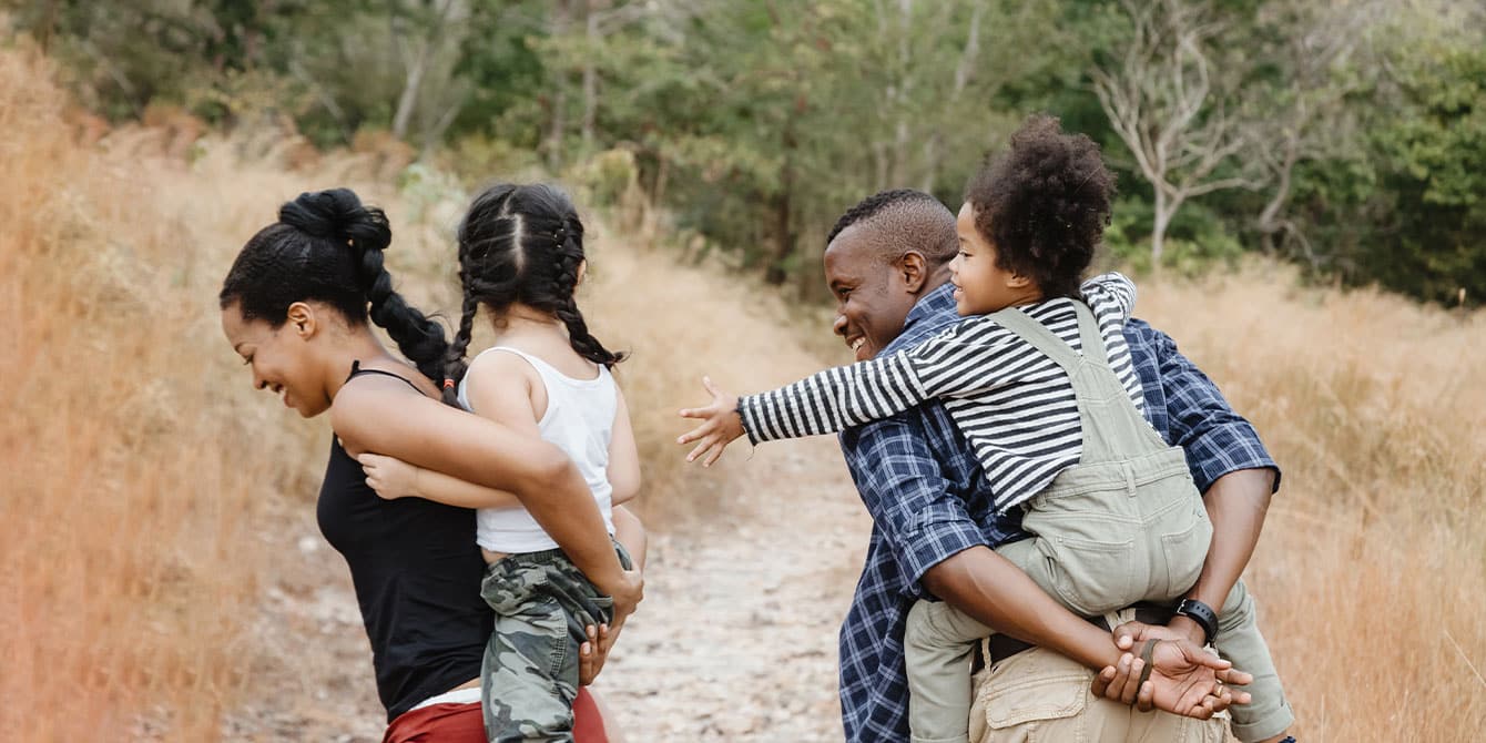 family hiking together on national park road trip