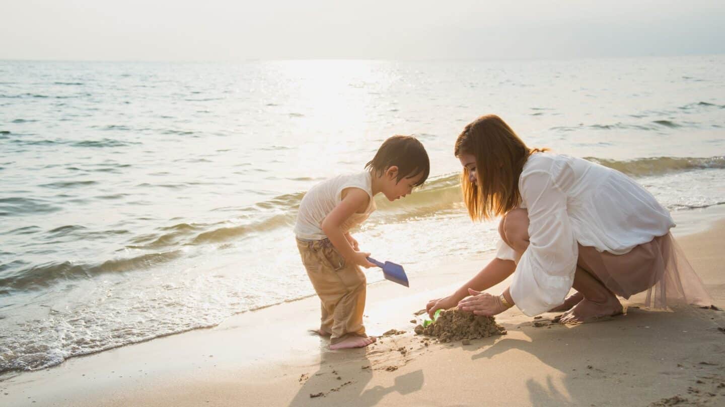 mom and young son playing on the beach, travel with one child