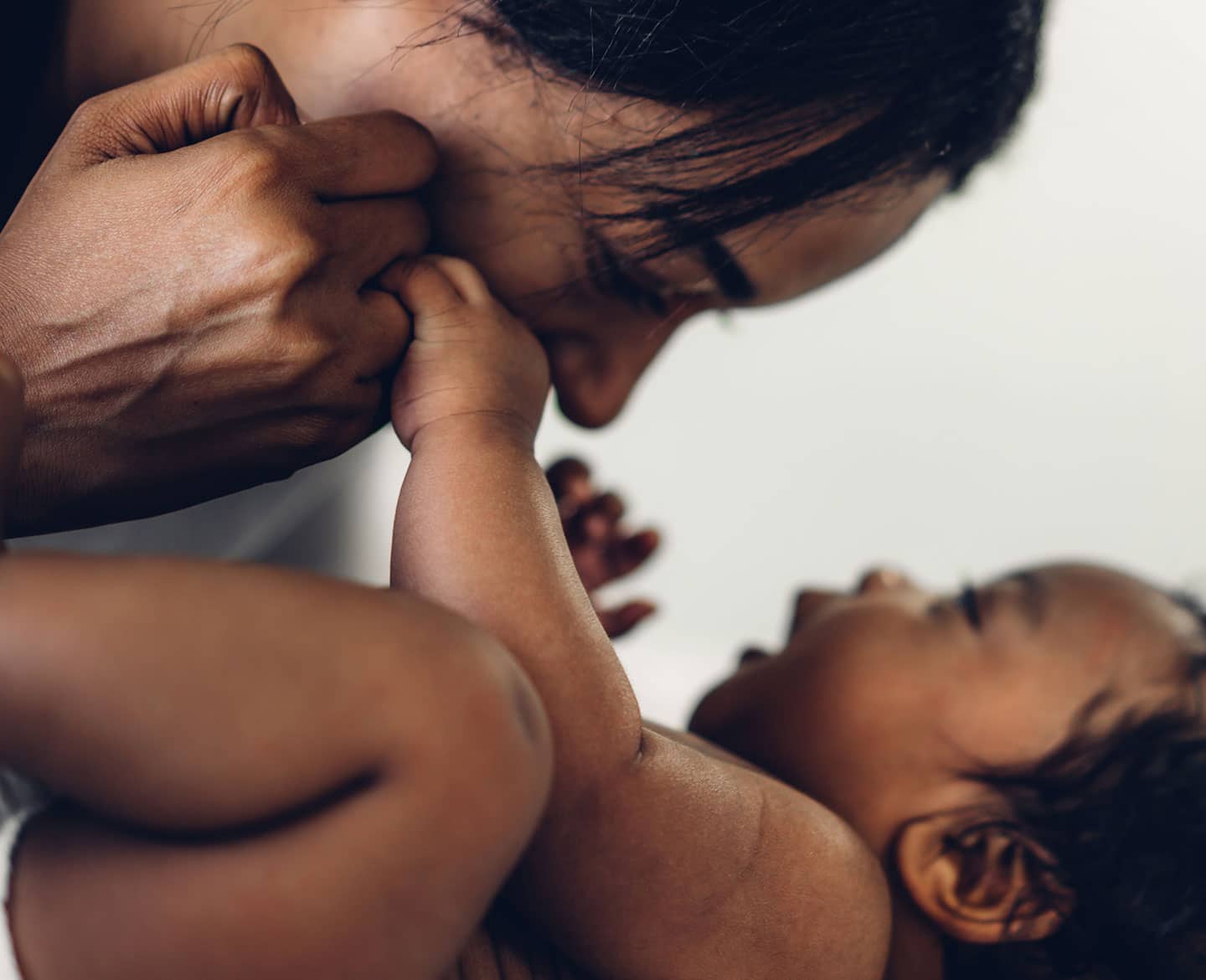 mom cuddling baby as she thinks about baby safety