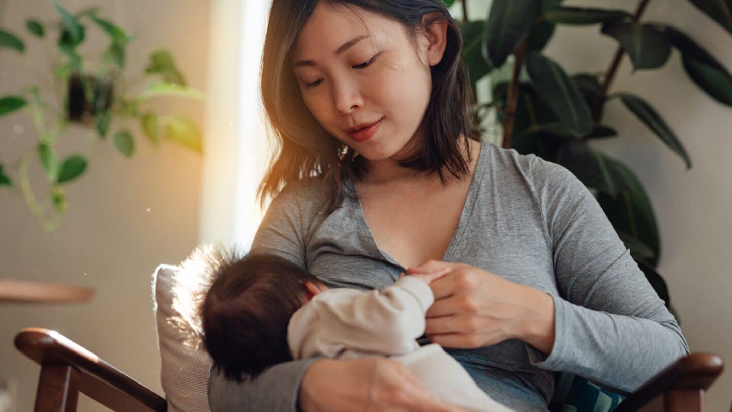 mother breastfeeding baby at home; regular breastfeeding is helpful for mastitis management