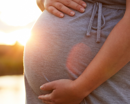 pregnant woman holding her belly in sunset cdc says most pregnancy related deaths are preventable