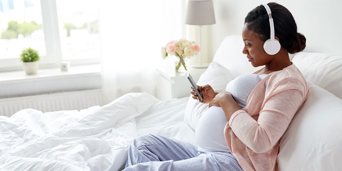 pregnant woman listening to podcasts for moms