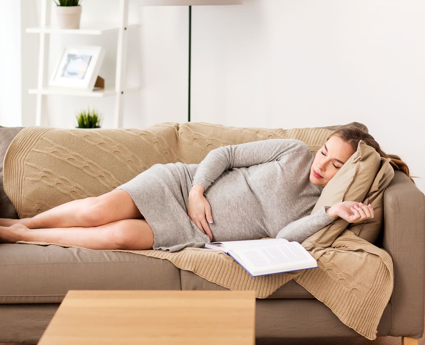 pregnant woman napping on couch showing pregnancy is hard