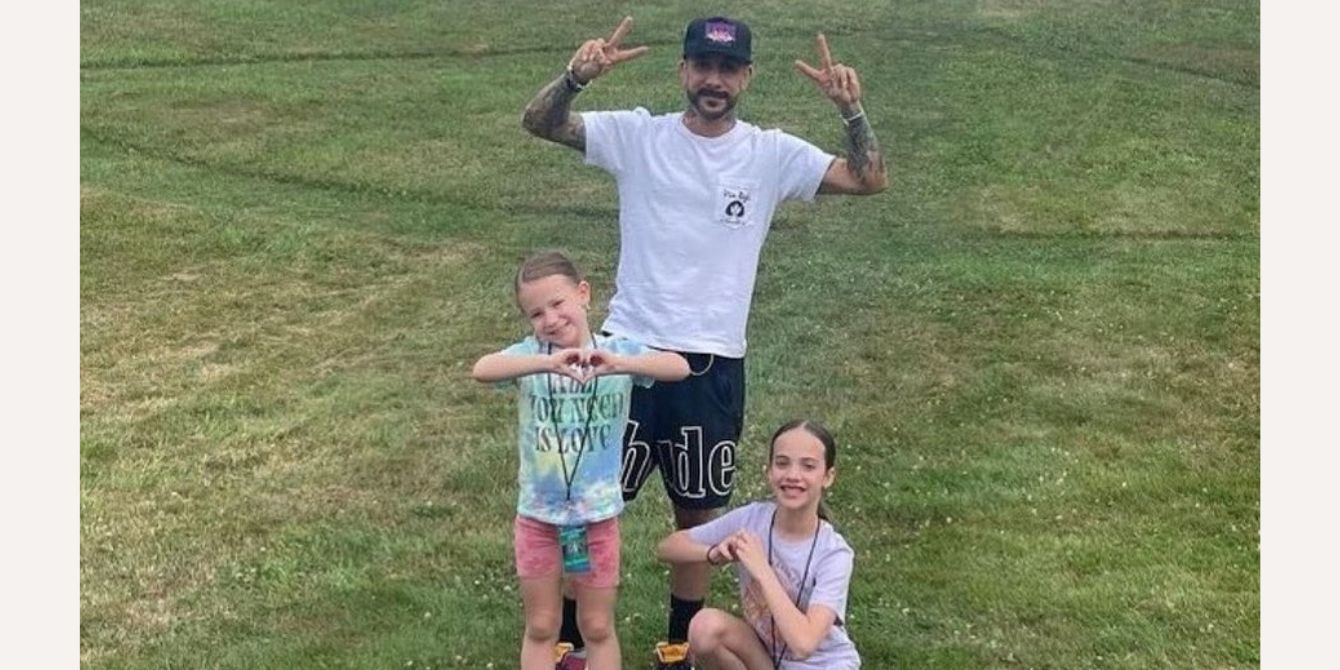 AJ McLean posing with children