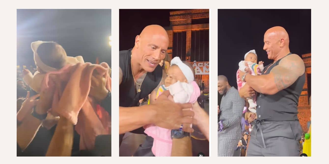 The Rock holding a baby after crowd-surfing