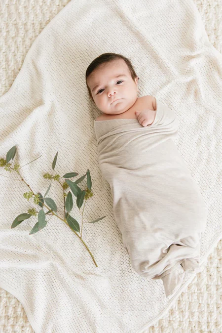 Solly Baby Swaddle, one of motherly's favorite newborn photo outfits