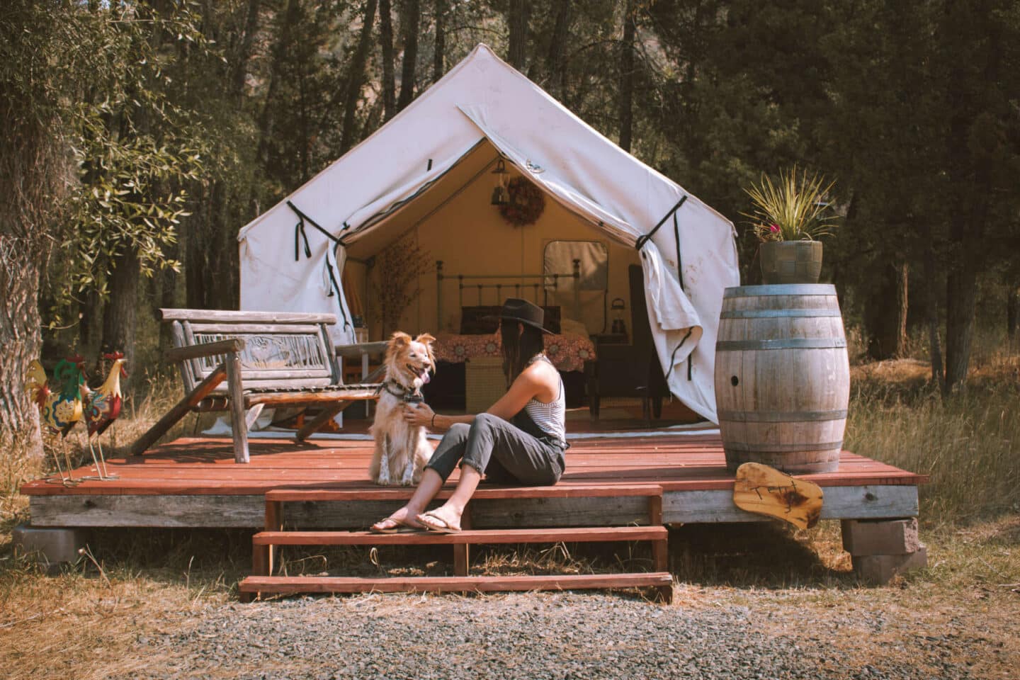 Woman and dog in front of glamping tent