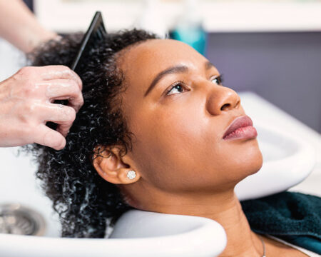 african american woman getting her hair washed in the hair salon