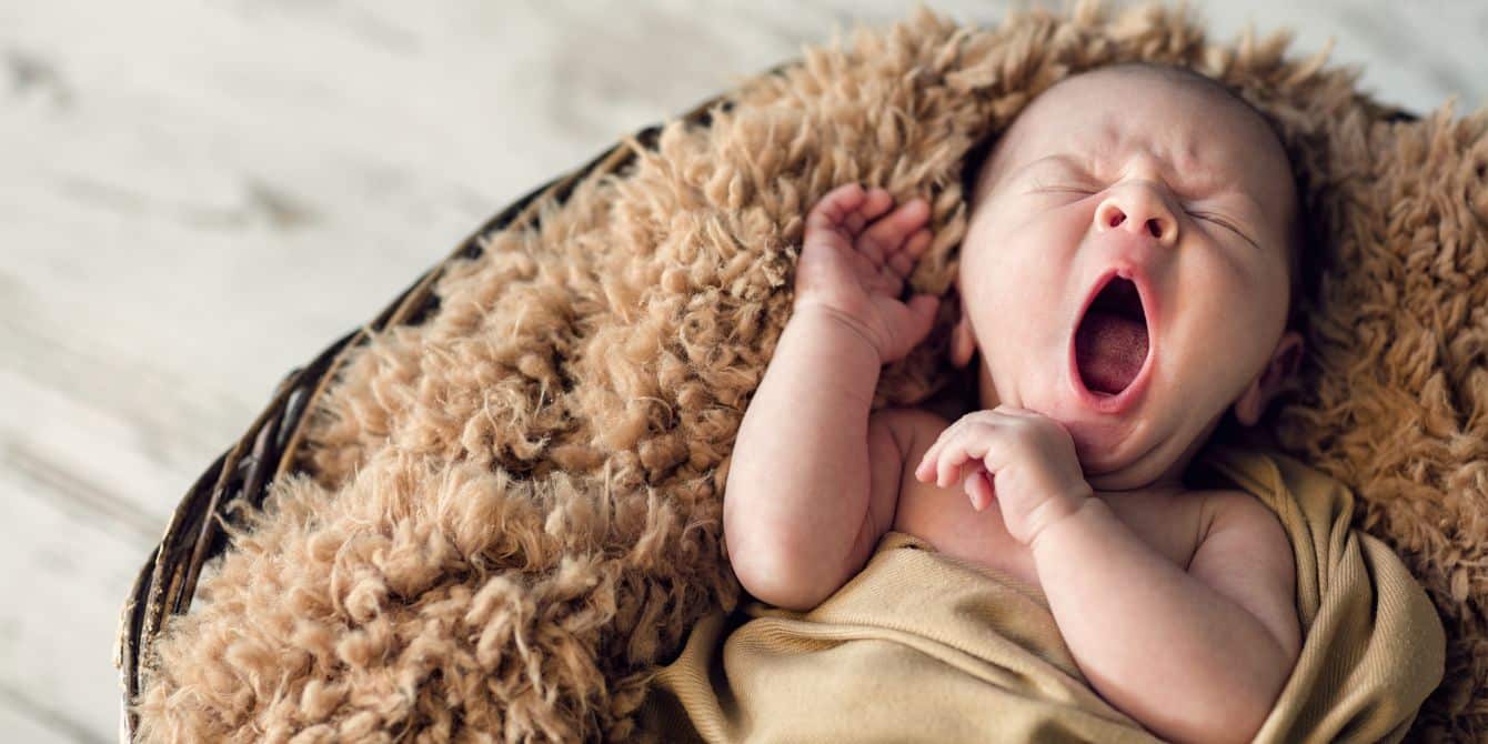 baby yawning in one of motherly's favorite newborn photo outfits