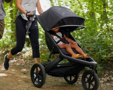 family jogging with child in Guava stroller 1
