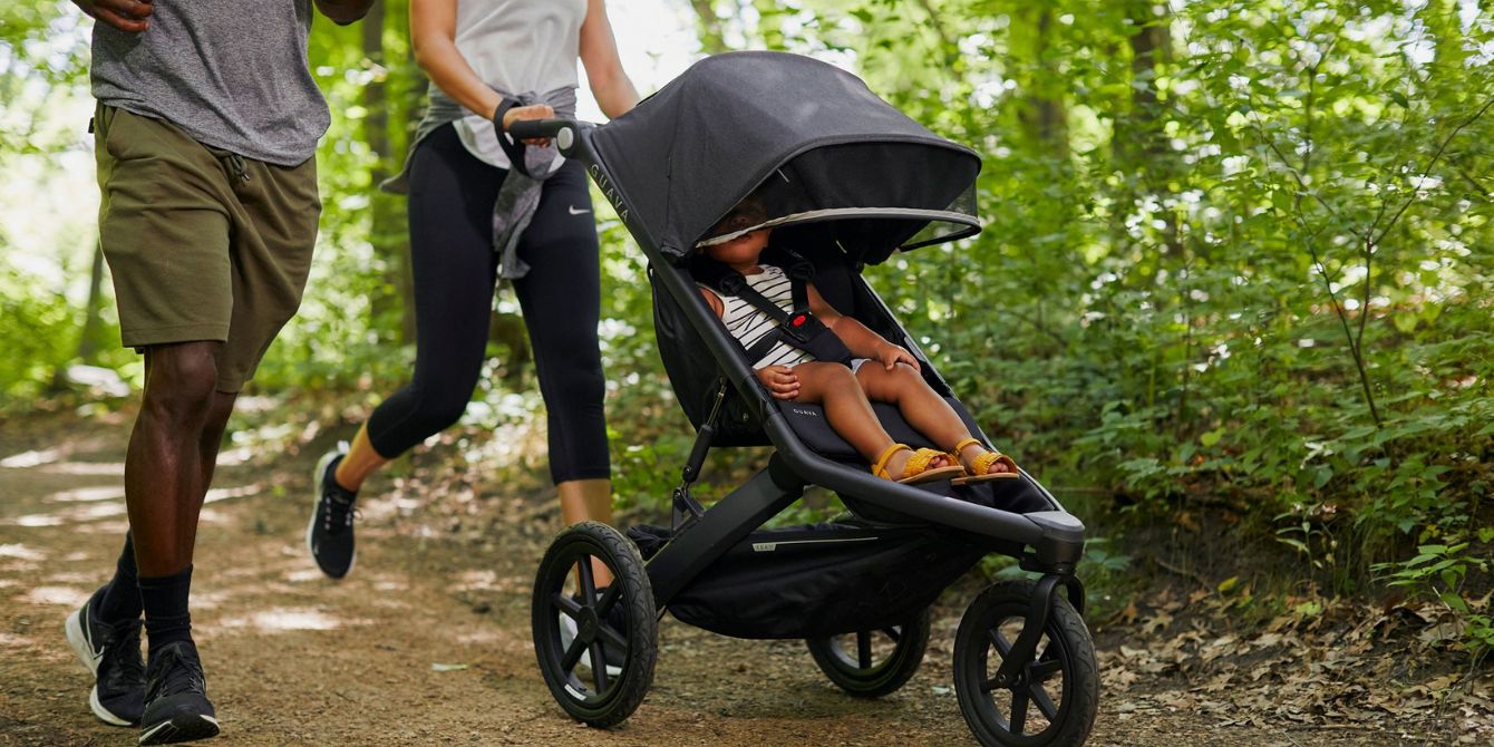family jogging with child in Guava stroller