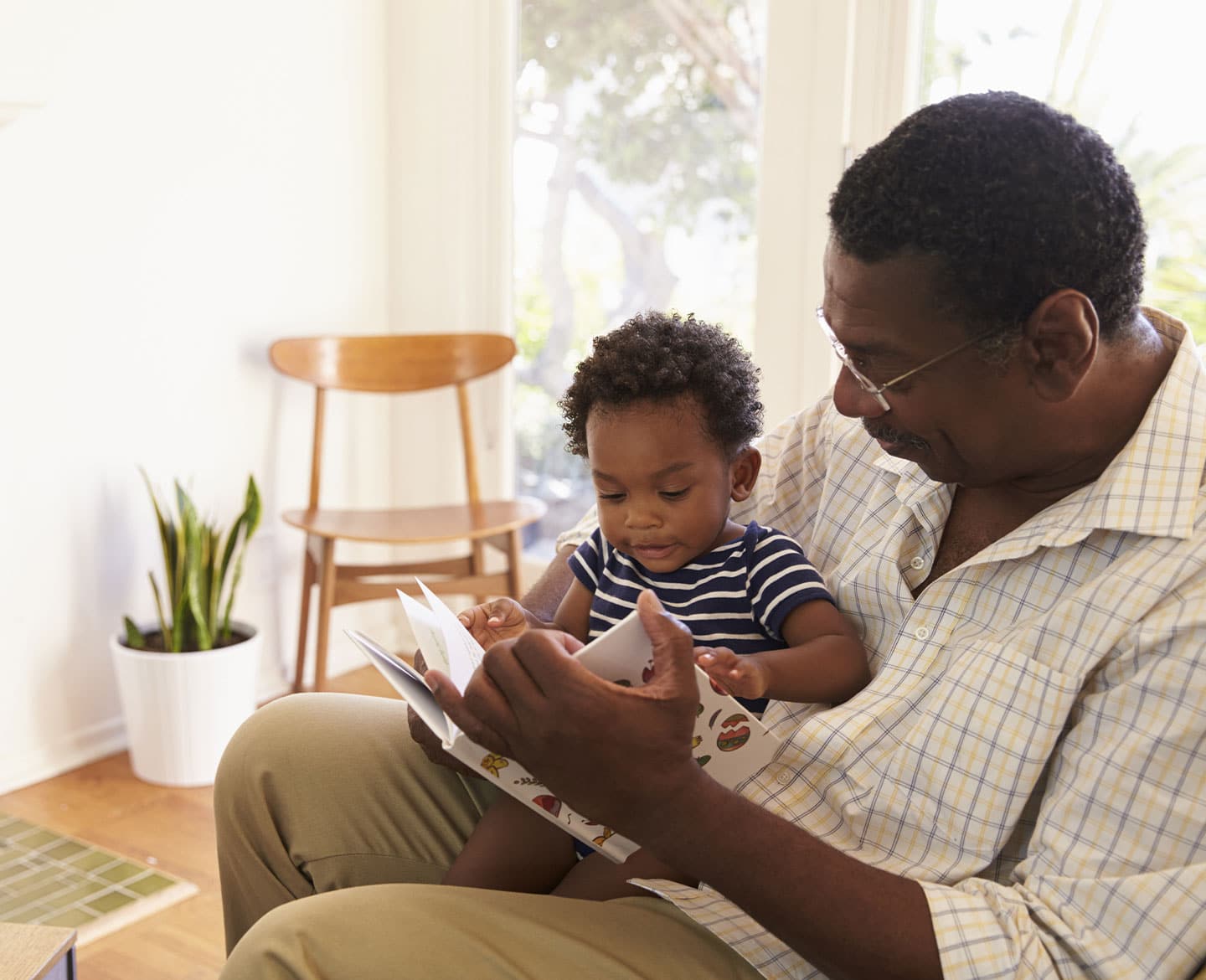 grandfather and grandson reading a book