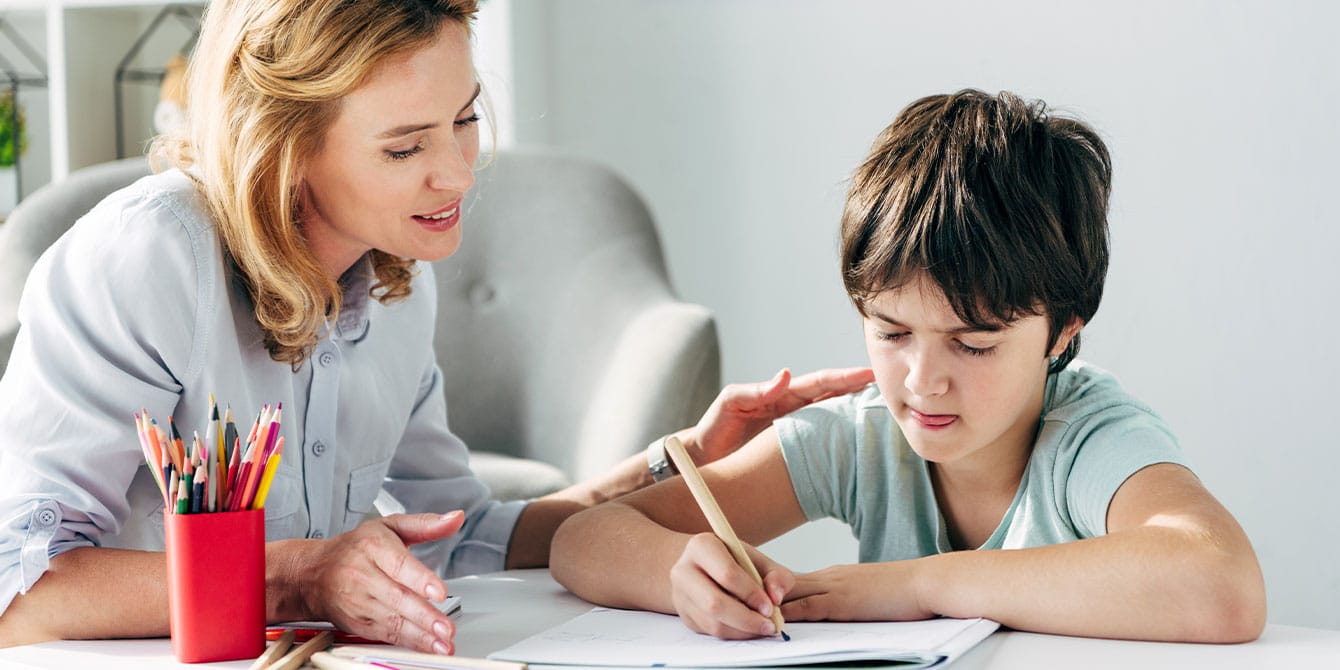 mom parenting a child with autism helping do homework