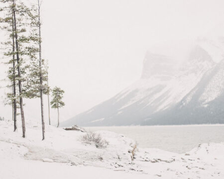 couple walking through the snow in the mountains -bucket list trips