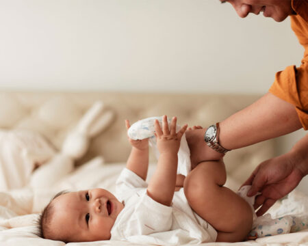 dad changing babys diaper