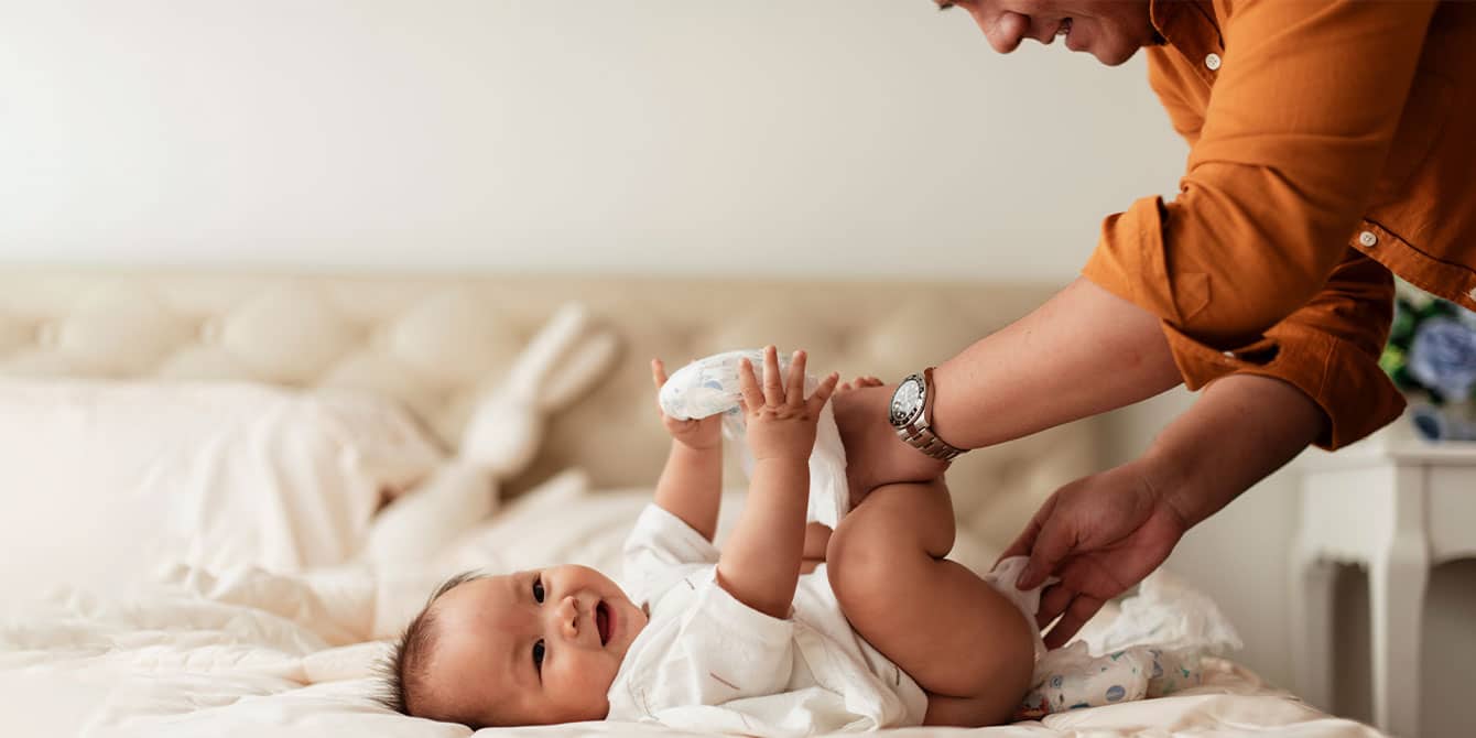 hands on dad changing baby diaper