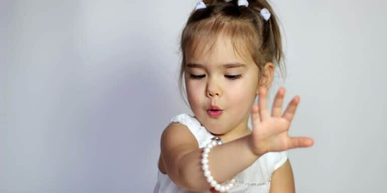 little girl looking at her bracelet- birthstones by month meanings