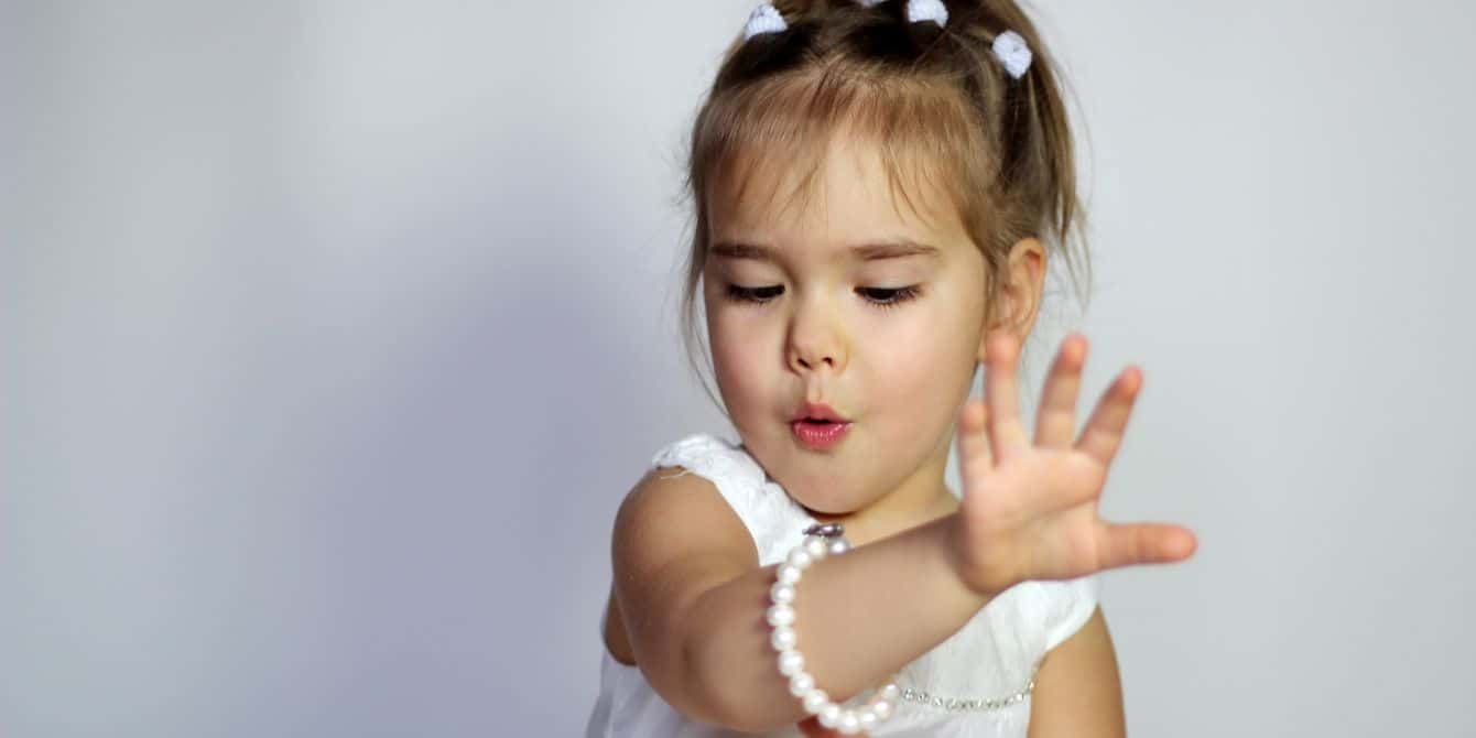 little girl looking at her bracelet- birthstones by month meanings