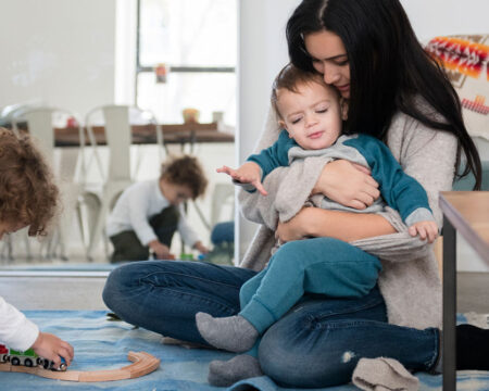 mom playing on the floor with her two sons