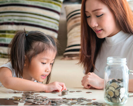 mom teaching her daughter to count money