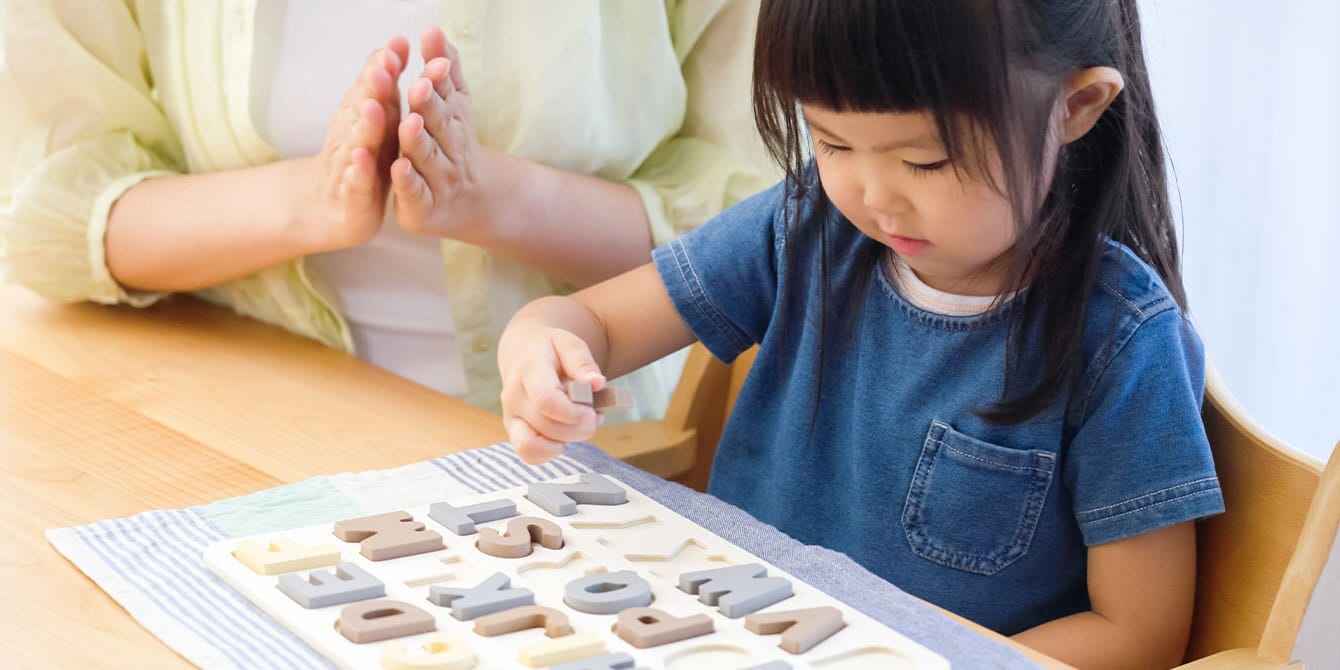 mom teaching kid the alphabet - working mom