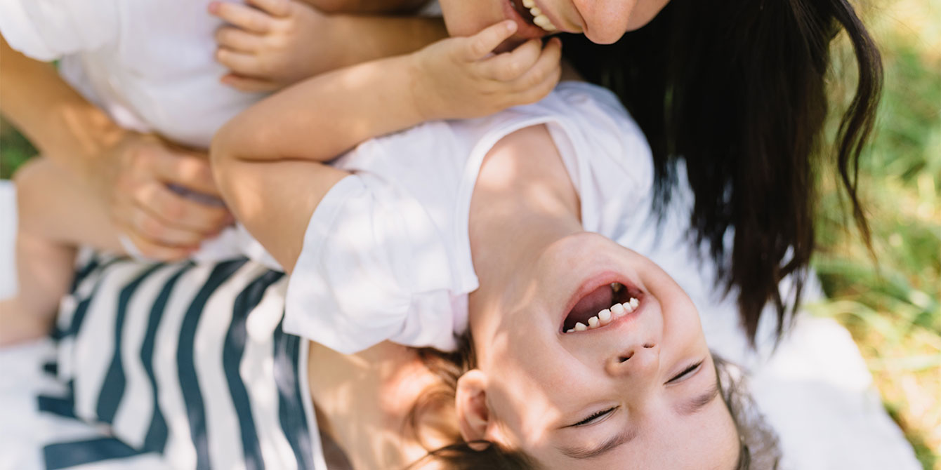 https://www.mother.ly/wp-content/uploads/2022/11/mom-tickling-her-son-outdoors.jpg