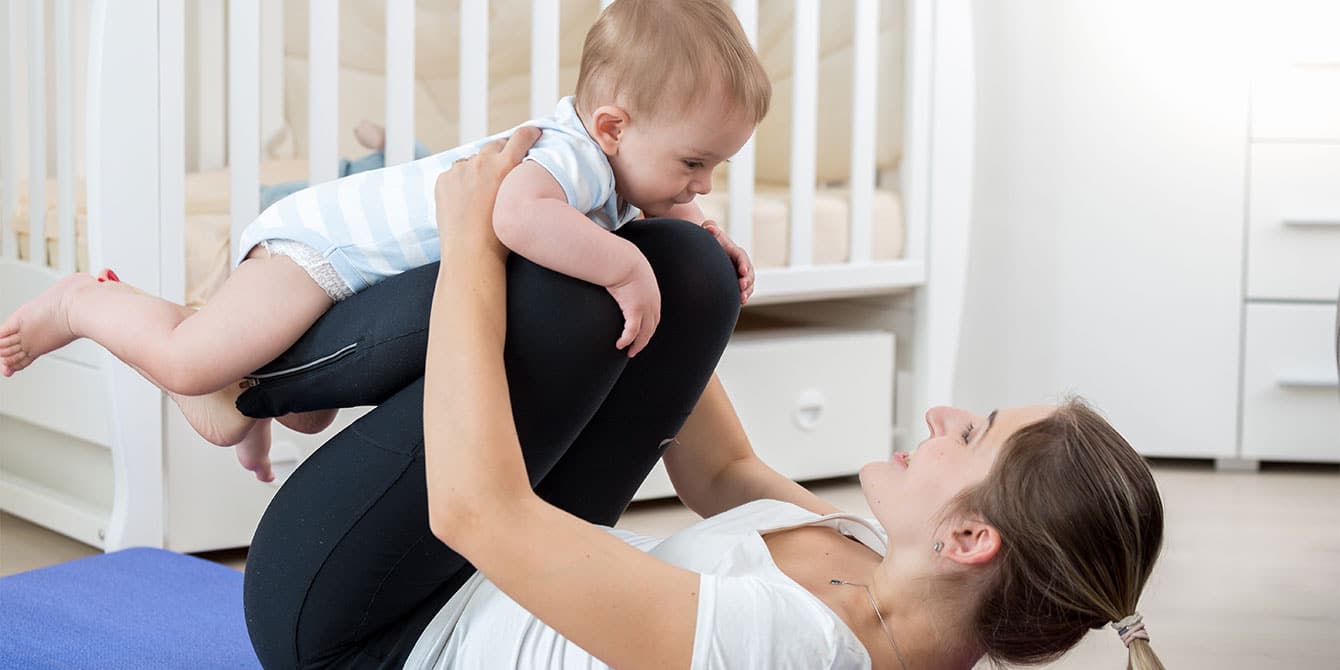 mom practicing yoga after having second baby