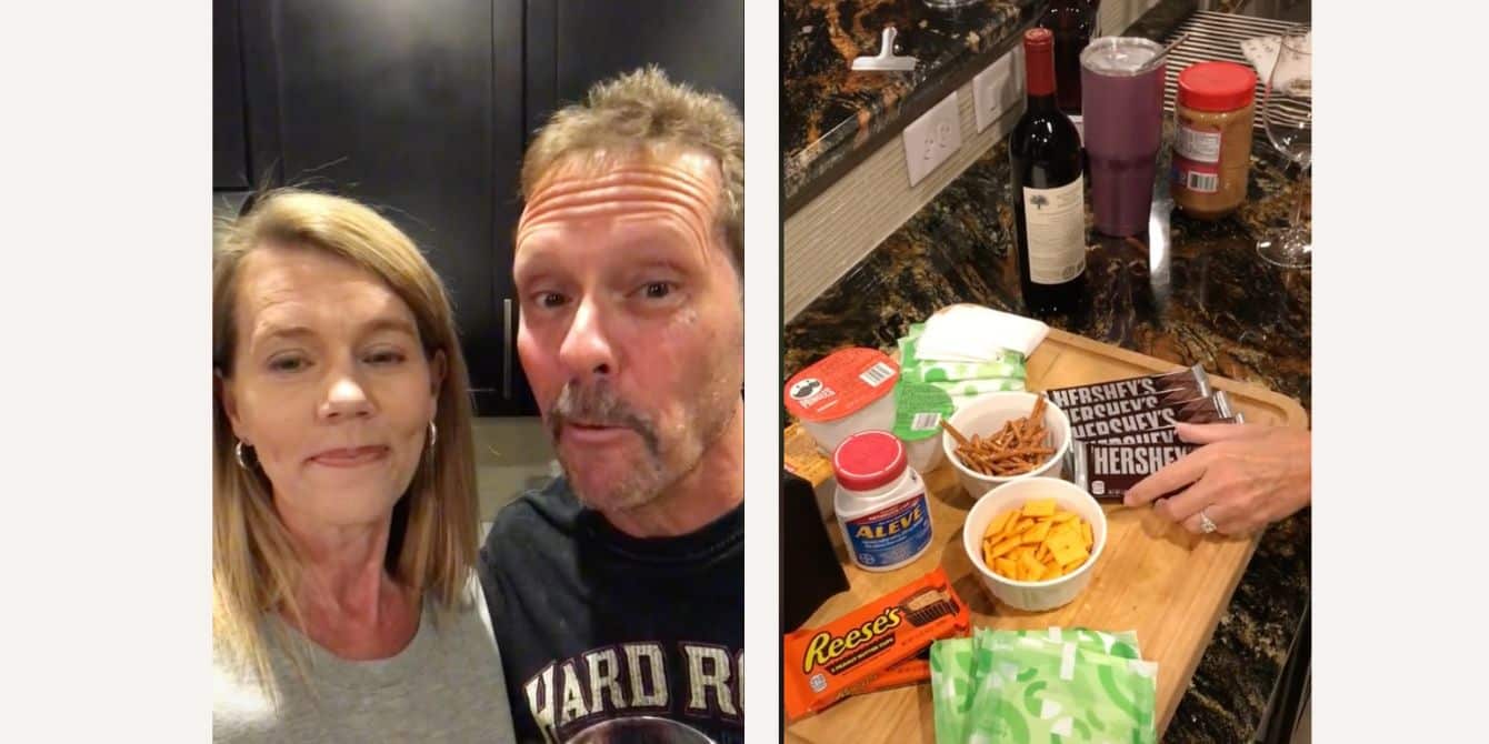 Two parents pose next to their 'period board' they made for their daughters.