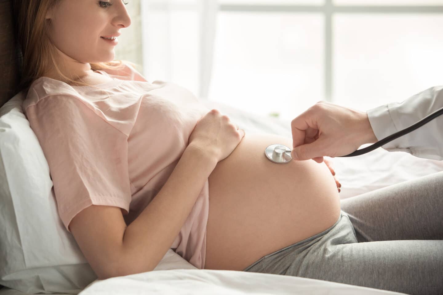 Pregnant Woman Getting Checked by Doctor