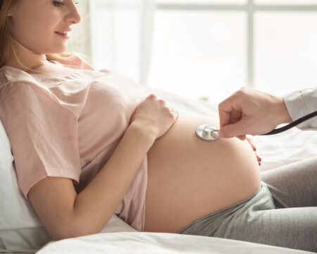 pregnant woman checked by doctor
