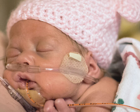 premature baby laying on moms chest in hospital