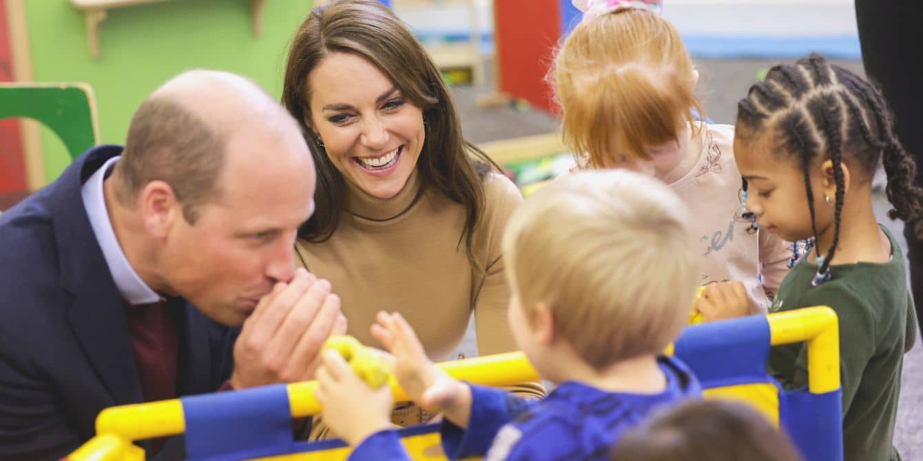 Prince William and Princess Kate laughing together at children's event