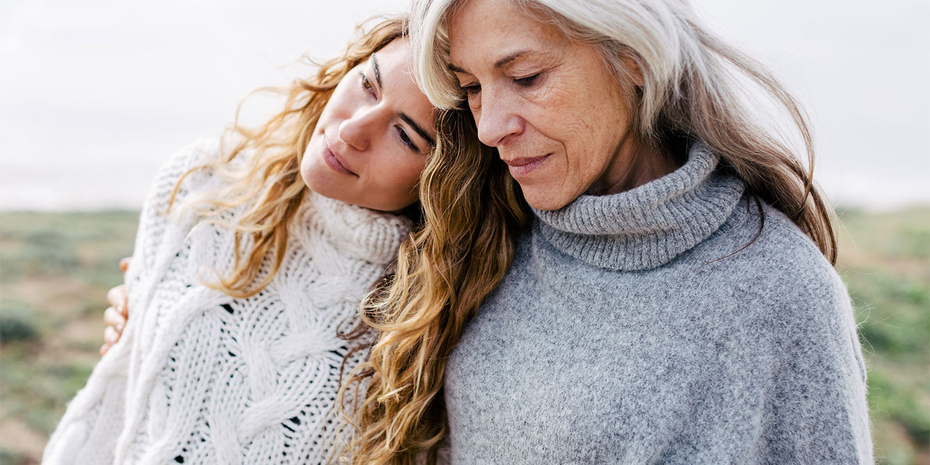 mom and daughter hugging outdoors- chronic loneliness