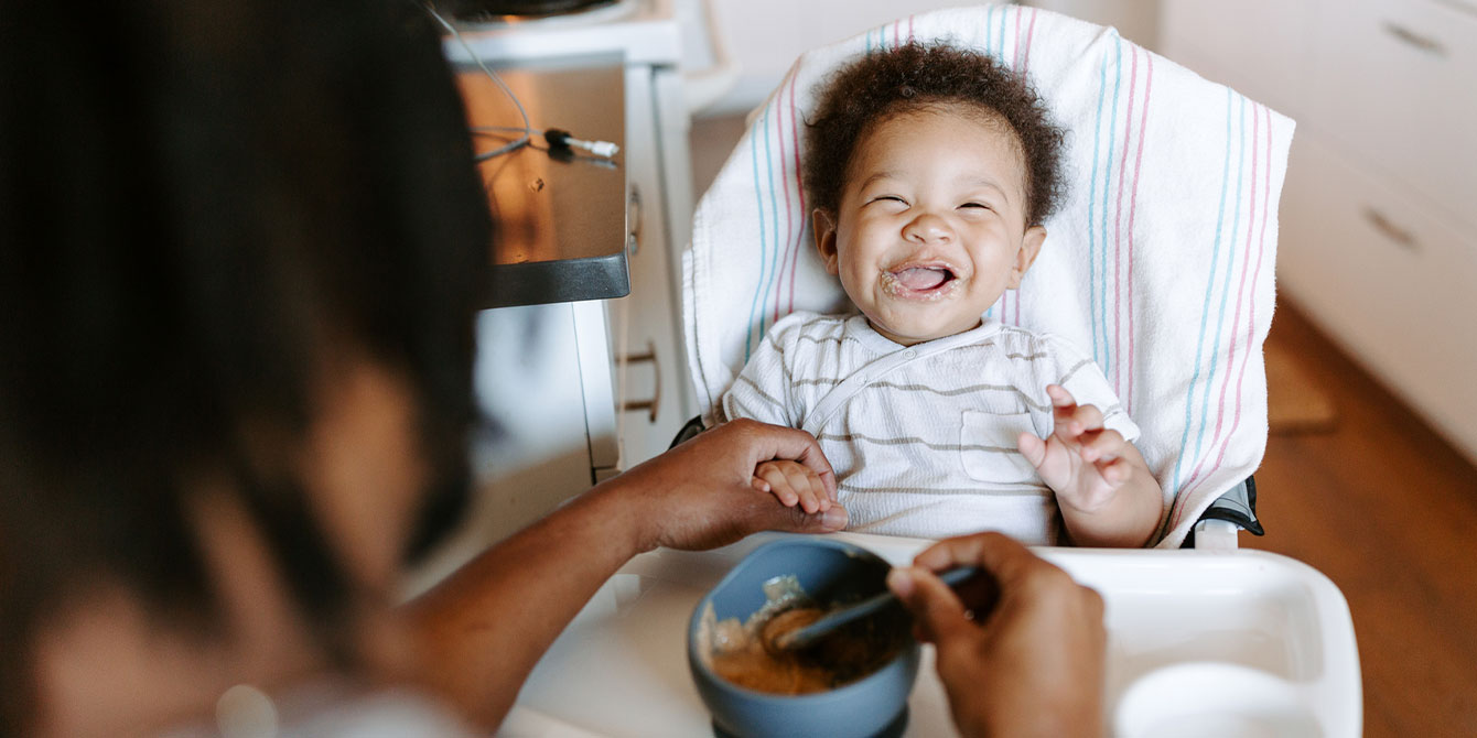 happy baby eating homemade baby food puree