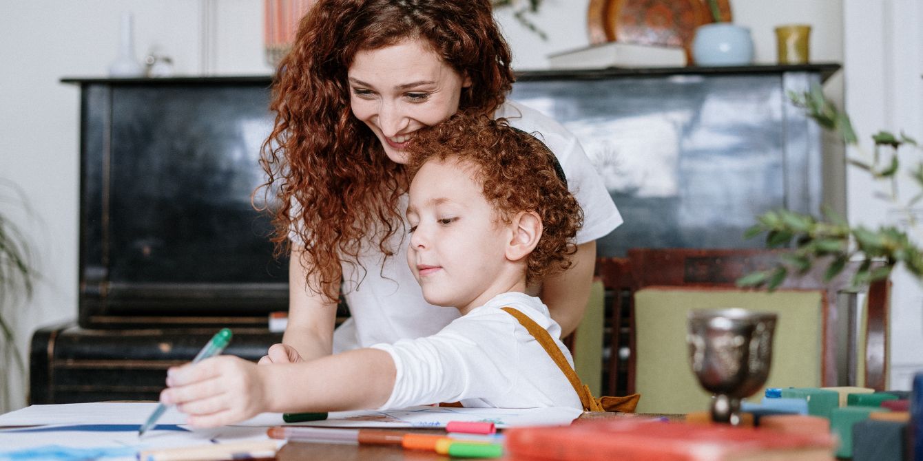 child sitting on moms lap coloring - valentine's day coloring pages