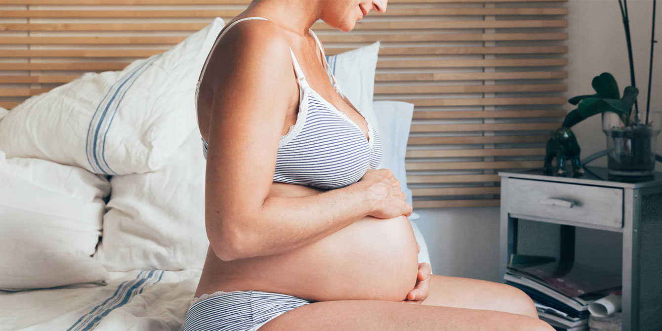 pregnant woman looking at her belly being pregnant at 46