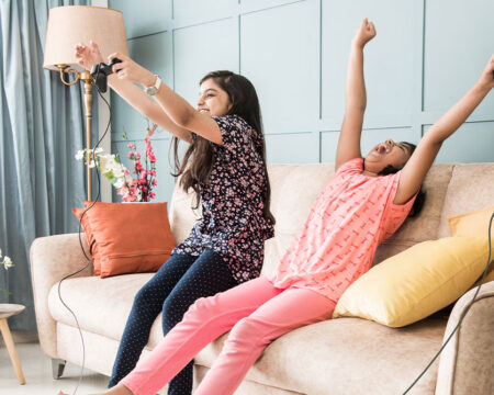 two young girls playing video games